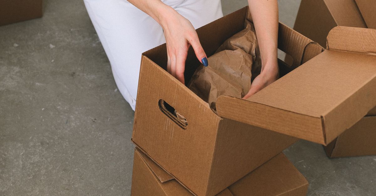 Moving boxes near an open storage unit.